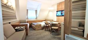 a bedroom with a bed and a table and a couch at Apartments KOP Konaci in Kopaonik