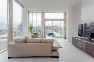 a living room with a couch and a large window at Luxury 1Bed In Converted Warehouse Next To London Excel in London