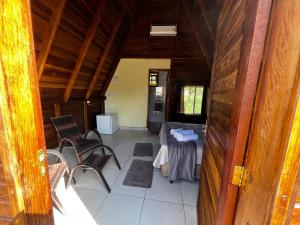 a view of a room with a table and chairs at Chalé da Chapada in Chapada dos Guimarães
