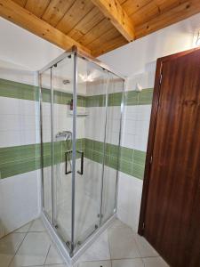 a shower in a bathroom with green and white stripes at Soleil Beach House in Santa Maria
