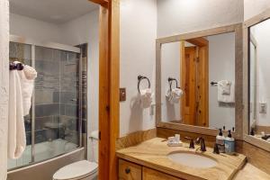 a bathroom with a sink and a toilet and a mirror at Predock 3B in Taos Ski Valley +25 photos