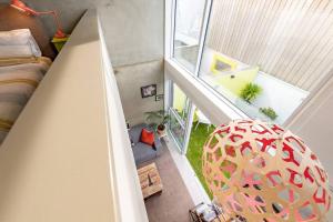 an attic room with a bed and a chair at Canvas Apartment in Wellington