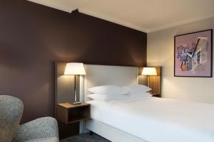 a hotel room with a bed and a chair at Delta Hotels by Marriott Bristol City Centre in Bristol