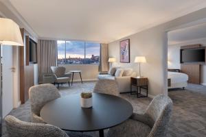 a hotel room with a table and a bed at Delta Hotels by Marriott Bristol City Centre in Bristol