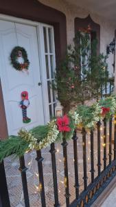 a porch with christmas wreaths on the front door at Las Golondrinas de Henche 
