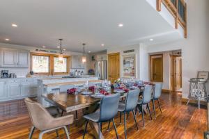 a kitchen and dining room with a wooden table and chairs at New & Stunning Chalet! Reno'd, Hot-Tub, Barrel Sauna, Slope Views, Fire Pit in Ellicottville