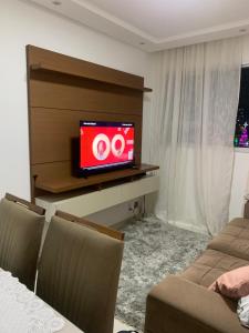 sala de estar con TV en la pared en Apartamento Temporada Mobiliado Proximo a Praia, en Vila Velha