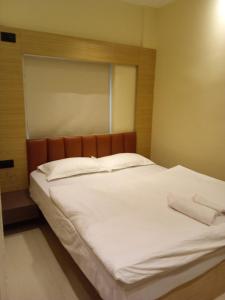 a bed with two white pillows on top of it at Hotel Skyking in Gauripur