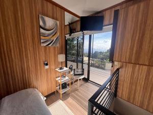 a bedroom with a bed and a balcony with a view at Villazul 2 in Poás