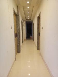 an empty hallway in a building with white walls at Hotel Skyking in Gauripur