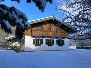 a house with snow in front of it at Ferienhaus Lois & Lisl in Schleching