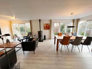 a living room with a table and chairs at Bungalow in Makkum near Lake Beach in Holle Poarte