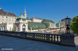 a bridge in front of a building with a street light at Home Suites Home in Vienna