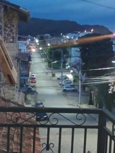 a view from a balcony of a parking lot at night at Casa em sao thome das letras in São Thomé das Letras +8 photos