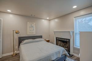 a bedroom with a bed and a fireplace at Downtown Beaufort Townhome - Short walk to Waterfront Park - Less than 10 minutes to Parris Island in Beaufort