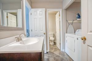 a white bathroom with a sink and a toilet at Downtown Beaufort Townhome - Short walk to Waterfront Park - Less than 10 minutes to Parris Island in Beaufort +21 photos