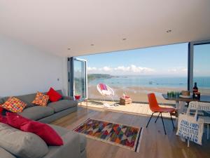 a living room with a view of the ocean at Ty Mair in Tenby