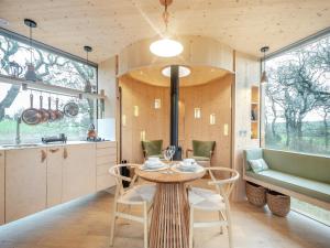 a kitchen and dining room with a table and chairs at The Treehouse Caerlaverock - Uk45028 in Carsethorn