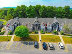 a large building with cars parked in a parking lot at Relax & Rejuvenate at 2BR Retreat with Pool & Gym in Shanty Bay