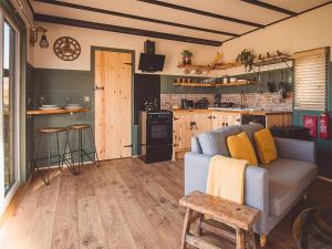 a living room with a couch and a kitchen at Cedar Lodge -uk44425 in Donyatt
