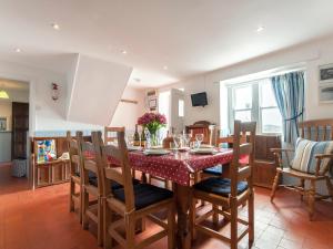 a kitchen and dining room with a table and chairs at Ty Gwyn Farmhouse in St. Davids
