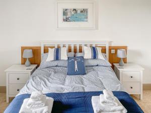a bedroom with a bed with two white night stands at Sealladh Na Mara in Arduaine