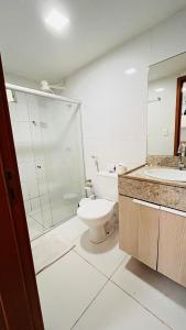 a bathroom with a toilet and a sink at Flat Tambaú - Beira-mar in João Pessoa