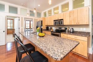 a kitchen with a granite counter top and wooden cabinets at Cherokee Farms Flat - New Listing in Habersham in Beaufort