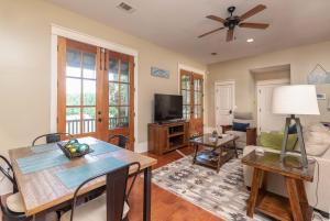 a living room with a ceiling fan and a table at Cherokee Farms Flat - New Listing in Habersham in Beaufort