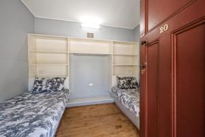 a small room with two beds and a door at Bright Cabin Park in Bright