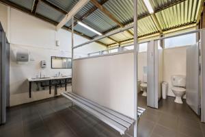 a bathroom with a toilet and a sink at Bright Cabin Park in Bright