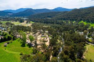 an aerial view of a park with mountains in the background at Bright Cabin Park in Bright