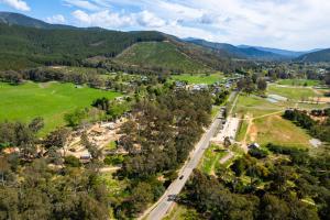 an aerial view of a village in the mountains at Bright Cabin Park in Bright