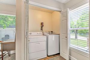 a kitchen with a washer and dryer next to a window at Pecan Hill House in Waco