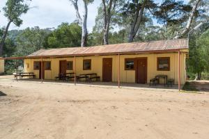 a small yellow building with picnic tables in it at Bright Cabin Park in Bright