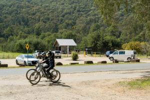 a person riding a bike on a dirt road at Bright Cabin Park in Bright