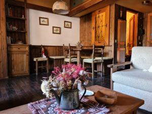 a living room with a table and a couch at Monolocale Pescasseroli Residence Palace in Pescasseroli