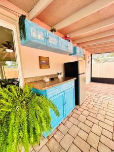 a kitchen with a blue counter and a refrigerator at Vintage Family Scape + heated pool&discount in Tampa