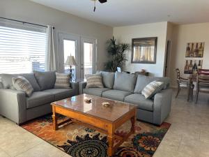 a living room with two couches and a coffee table at Golfers Getaway - Mesquite in Mesquite