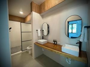 a bathroom with a sink and a mirror at 1 Corcega Beachfront Suites in Rincon