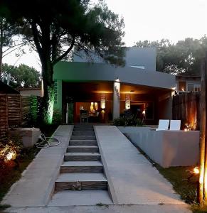 a house with a staircase leading to the front yard at Casa Boutique LUNA LUCIA in Monte Hermoso +32 photos