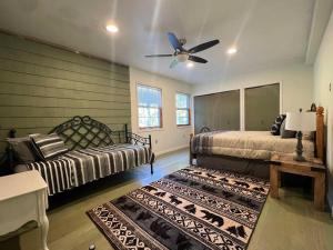 a bedroom with two beds and a ceiling fan at Emerald Shores in Coloma
