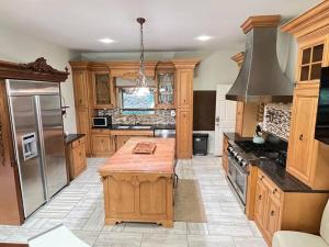 a large kitchen with wooden cabinets and a refrigerator at Emerald Shores in Coloma