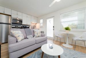 a living room with a couch and a table at Be A Nomad - Beachside Apartments in Jacksonville Beach