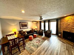a living room with a couch and a fireplace at White Mountains Getaway with amazing views! in Bartlett