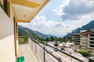 a balcony with a view of a city at Hotel Anuj Regency in Dharamshala