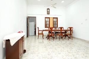 a dining room with a table and chairs at The Anam Hostel in Colombo