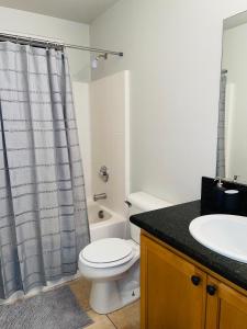 a bathroom with a toilet and a sink at 3BR King Suite/Near Strip/Wi-Fi in Las Vegas