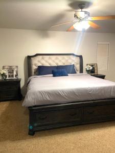a bedroom with a bed with a ceiling fan at 3BR King Suite/Near Strip/Wi-Fi in Las Vegas