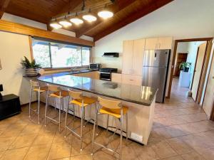a kitchen with a large island with bar stools at Cooinda Holiday Village House in American River